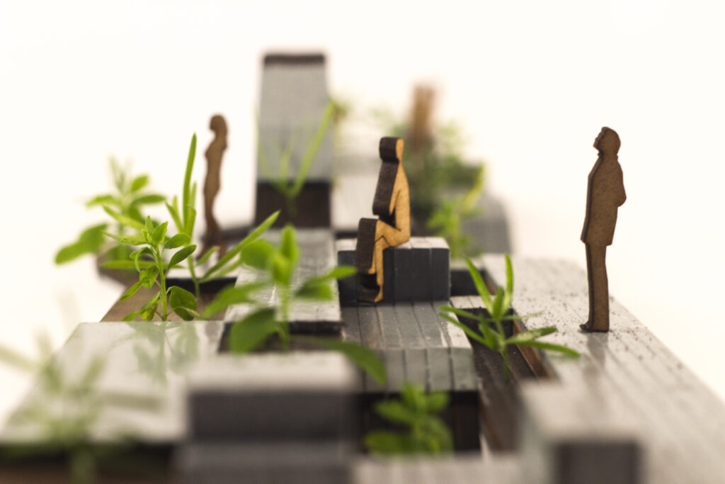 maquette van buitenruimte met silhouetten en planten, staande en zittende mensen en planten